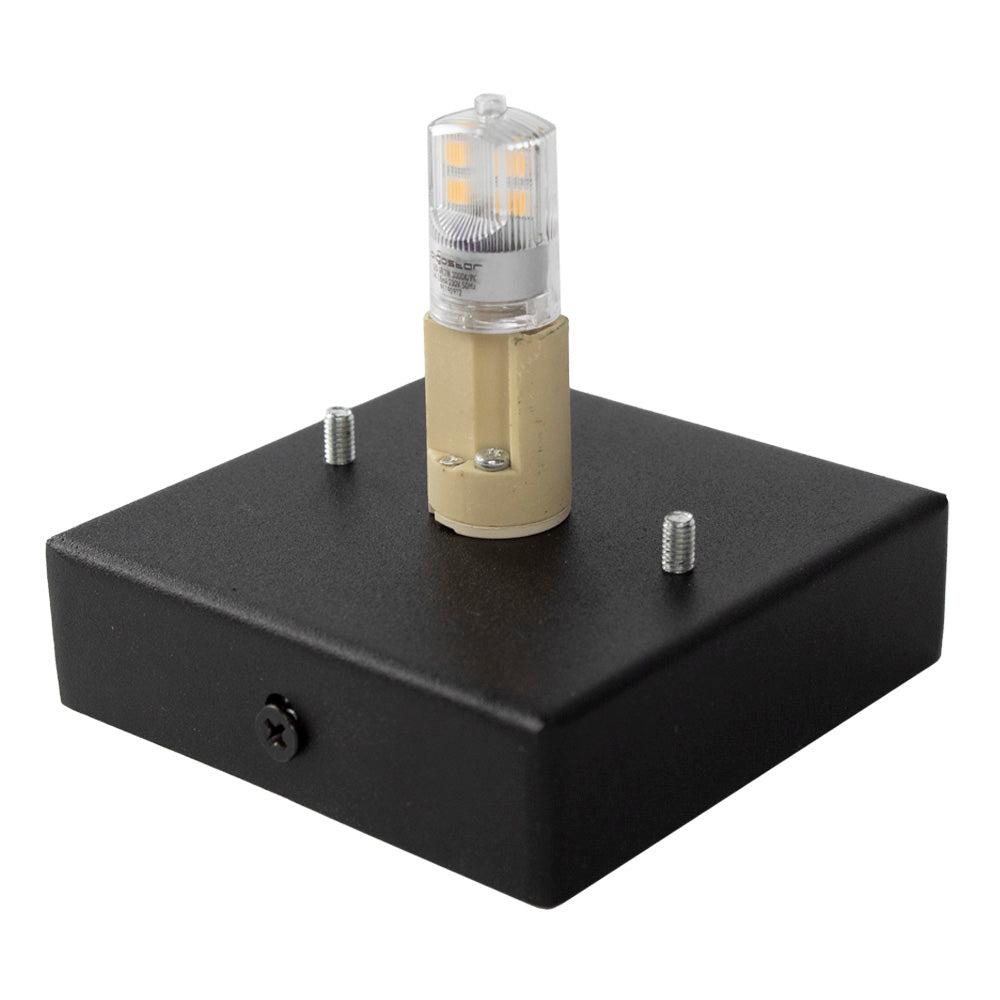 Schwarzer LED-Lampensockel mit G9-Fassung und eingebauter LED-Lampe, schräge Draufsicht des Produkts mit sichtbaren Schrauben und Befestigungsmöglichkeiten.