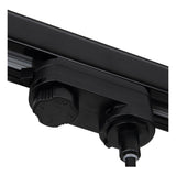 Nahaufnahme einer schwarzen 3-Phasen-Stromschienenbeleuchtung mit Drehknopf zur Stromeinstellung und Stromleiter, Seitenansicht der Stromschienenkupplung.