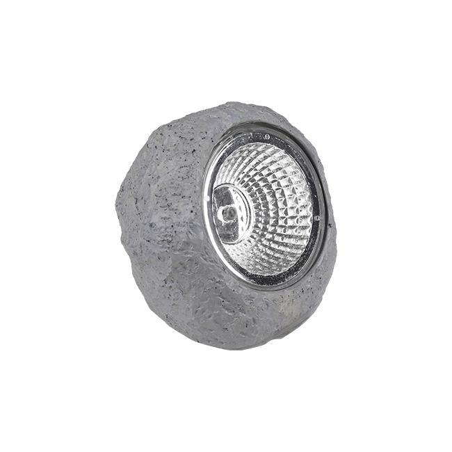 Dekorativer Gartenstrahler in Form eines grauen Steins mit integrierter LED-Beleuchtung, schräge Frontansicht.