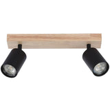 Zweiteiliger schwarzer Strahler an einem rechteckigen Deckenbalken aus Holz, Frontansicht. Moderner Deckenstrahler mit verstellbaren Zylinderlampen für fokussierte Beleuchtung.