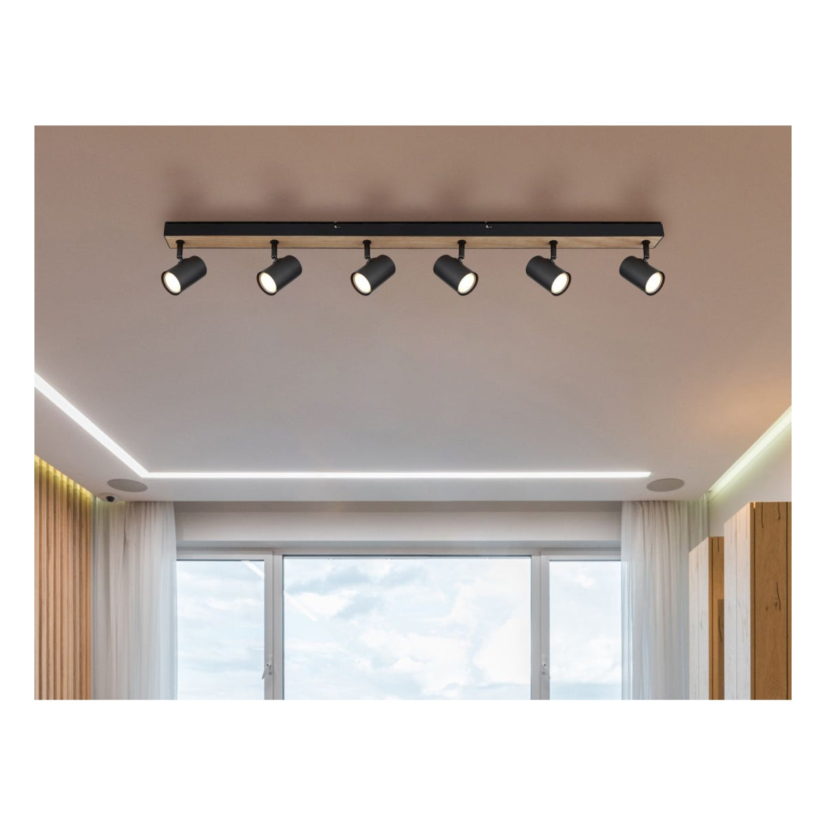 Schwarzer Deckenstrahler mit sechs verstellbaren Strahlern auf einer Metallschiene montiert, moderne Optik in einem zeitgenössischen Wohnzimmer, von unten betrachtet.