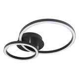 Moderne schwarze Deckenleuchte mit zwei LED-Lichtkreisen in asymmetrischem Design, schräg von unten vor weißem Hintergrund fotografiert.