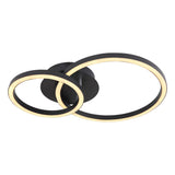 Moderne schwarze Deckenleuchte mit zwei überlappenden runden LED-Ringen, warmweißes Licht, schräg von unten gesehen vor weißem Hintergrund.