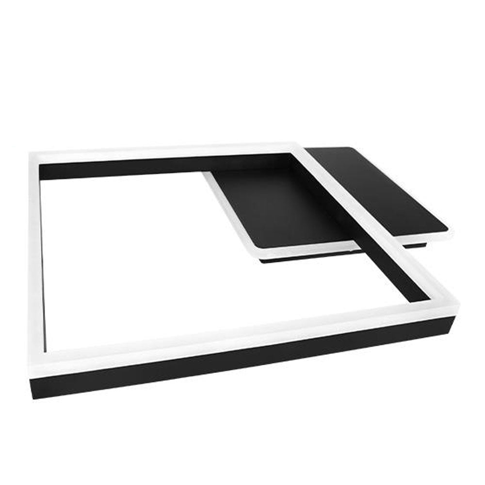 Luxuriöser moderner Couchtisch in schwarz-weißem Design mit geometrischer L-Form, Draufsicht.