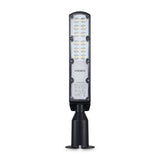 Vorderansicht der Videx LED-Außenleuchte Typ VL-SL10B-C005, mit schlankem, rechteckigem Design und mehreren LED-Lichtpunkten, montiert auf einem schwarzen Sockel zur Wand- oder Mastmontage.